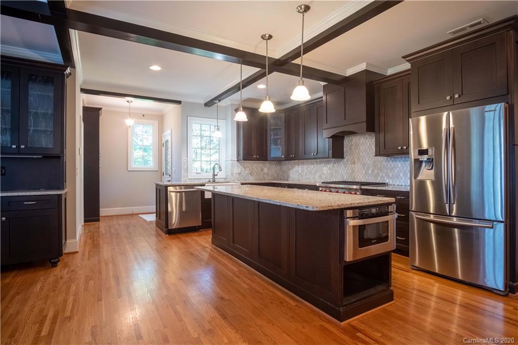 1844 Harris Road Charlotte, NC 28211 - Photo 8 of 29 a kitchen with stainless steel appliances granite countertop a stove a refrigerator and a view of living room