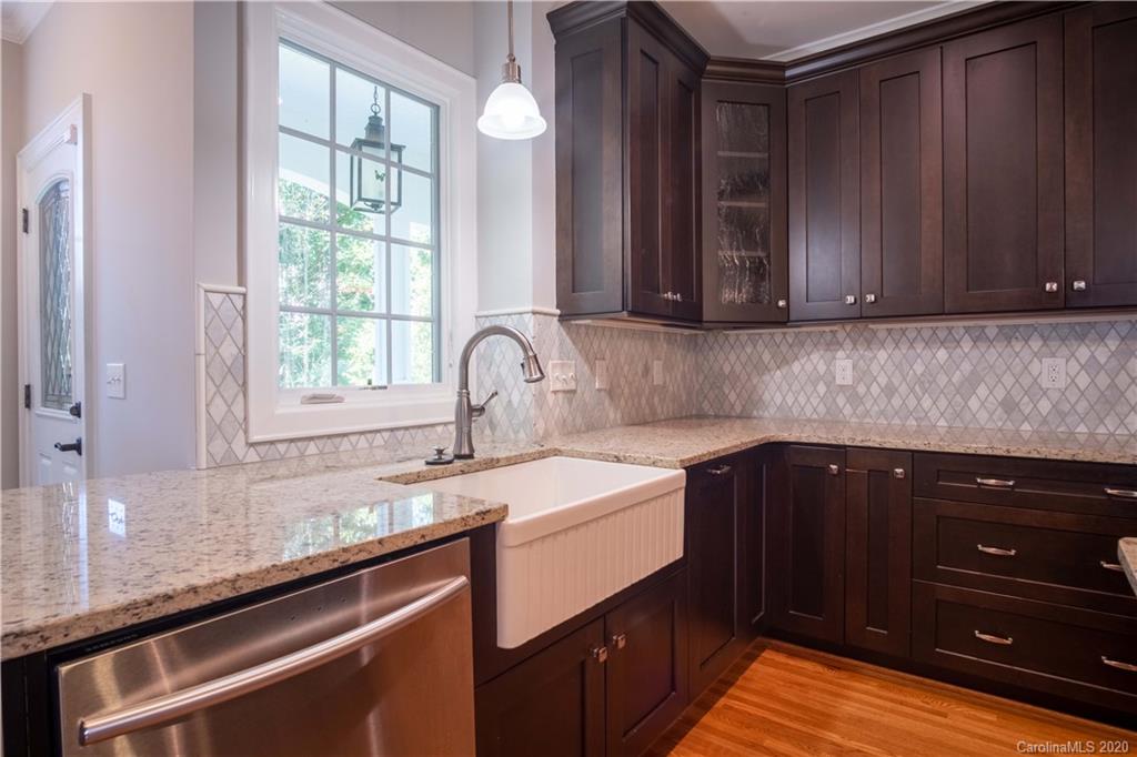 1844 Harris Road Charlotte, NC 28211 - Photo 9 of 29 a kitchen with granite countertop a sink and wooden cabinets