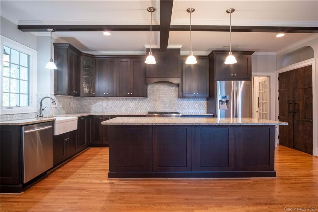 1844 Harris Road Charlotte, NC 28211 - Photo 10 of 29 a kitchen with a refrigerator and wooden cabinets