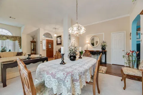 a view of a dining room with furniture and chandelier