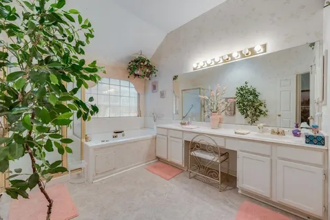 a spacious bathroom with a double vanity sink and a mirror