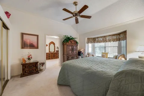 a bedroom with a large bed and a window