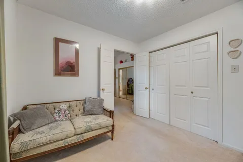 a living room with furniture and a ceiling fan