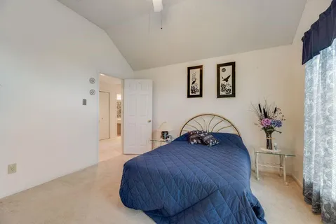 a bedroom with a bed and a table
