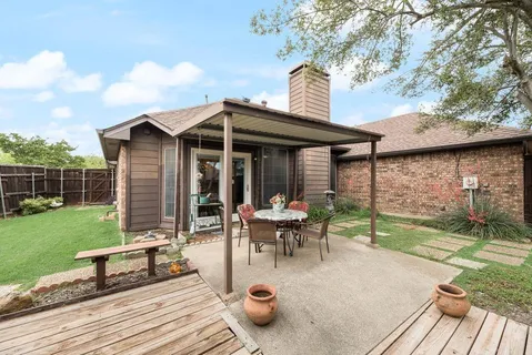 a view of a house with backyard sitting area and garden