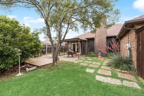 a view of a house with backyard and sitting area
