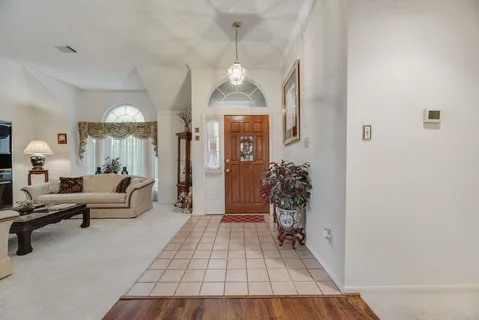 a living room with furniture and a chandelier