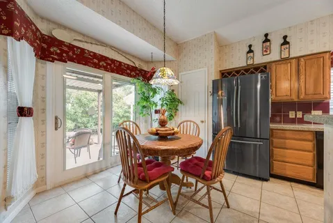 a dining room with furniture a chandelier and window