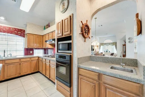 a kitchen with stainless steel appliances granite countertop a sink and cabinets