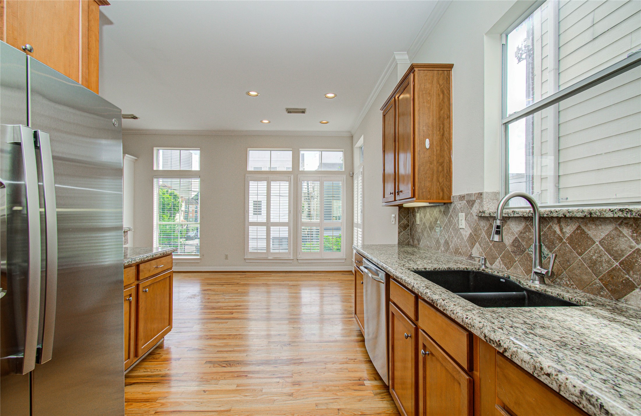 501 Leverkuhn Street Houston, TX 77007 - Photo 12 of 31 a kitchen with stainless steel appliances granite countertop a sink a stove and a wooden floors