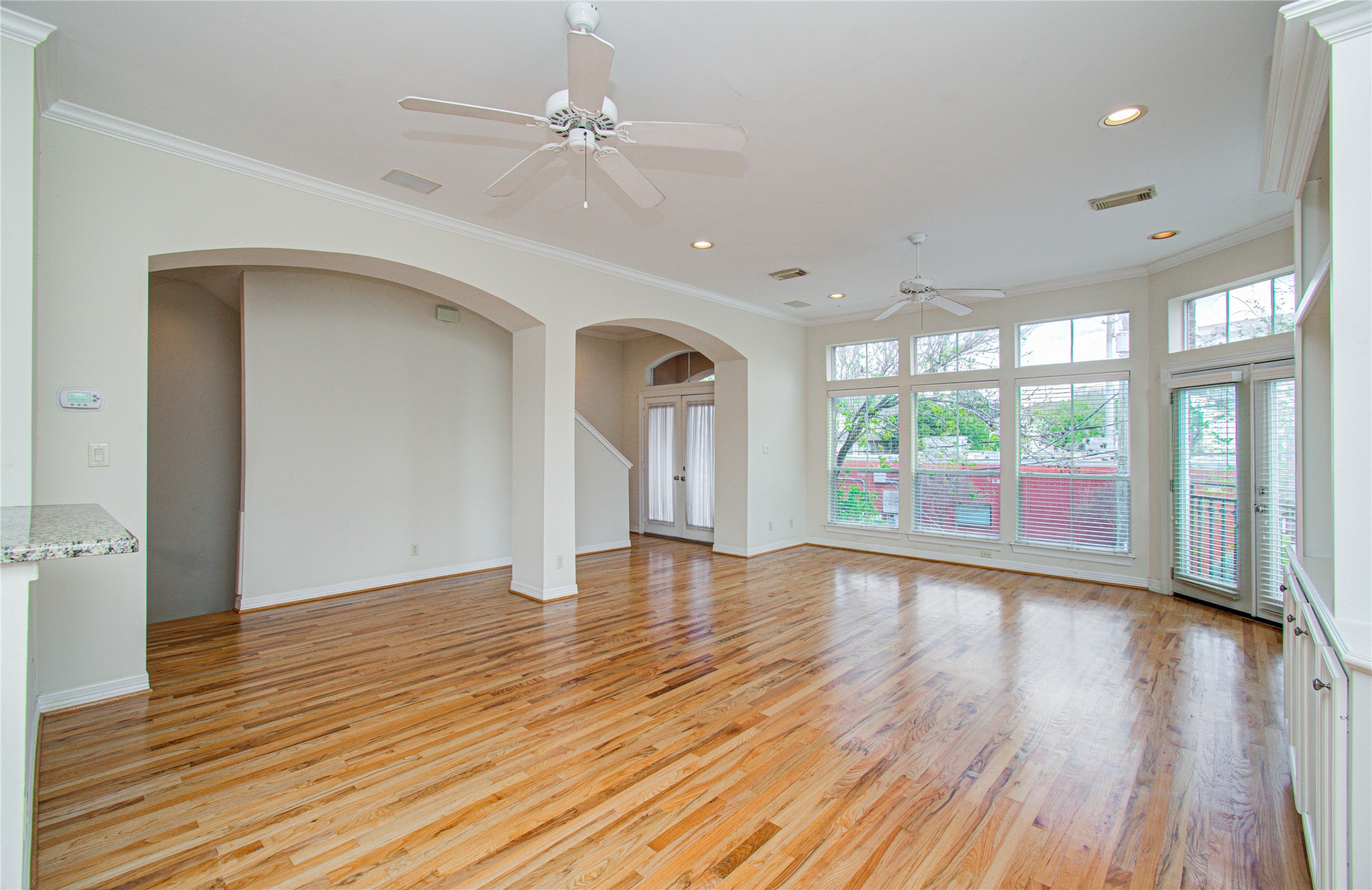 501 Leverkuhn Street Houston, TX 77007 - Photo 15 of 31 a view of an empty room with wooden floor and a window