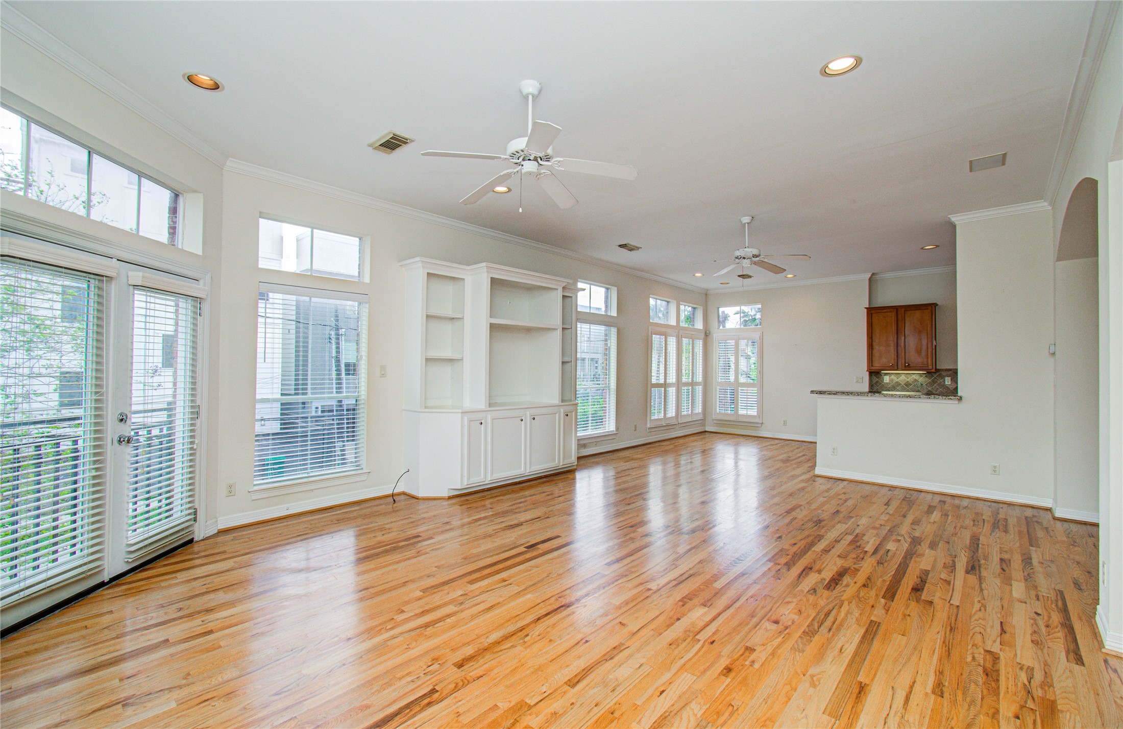 501 Leverkuhn Street Houston, TX 77007 - Photo 17 of 31 a view of an empty room with wooden floor and a window