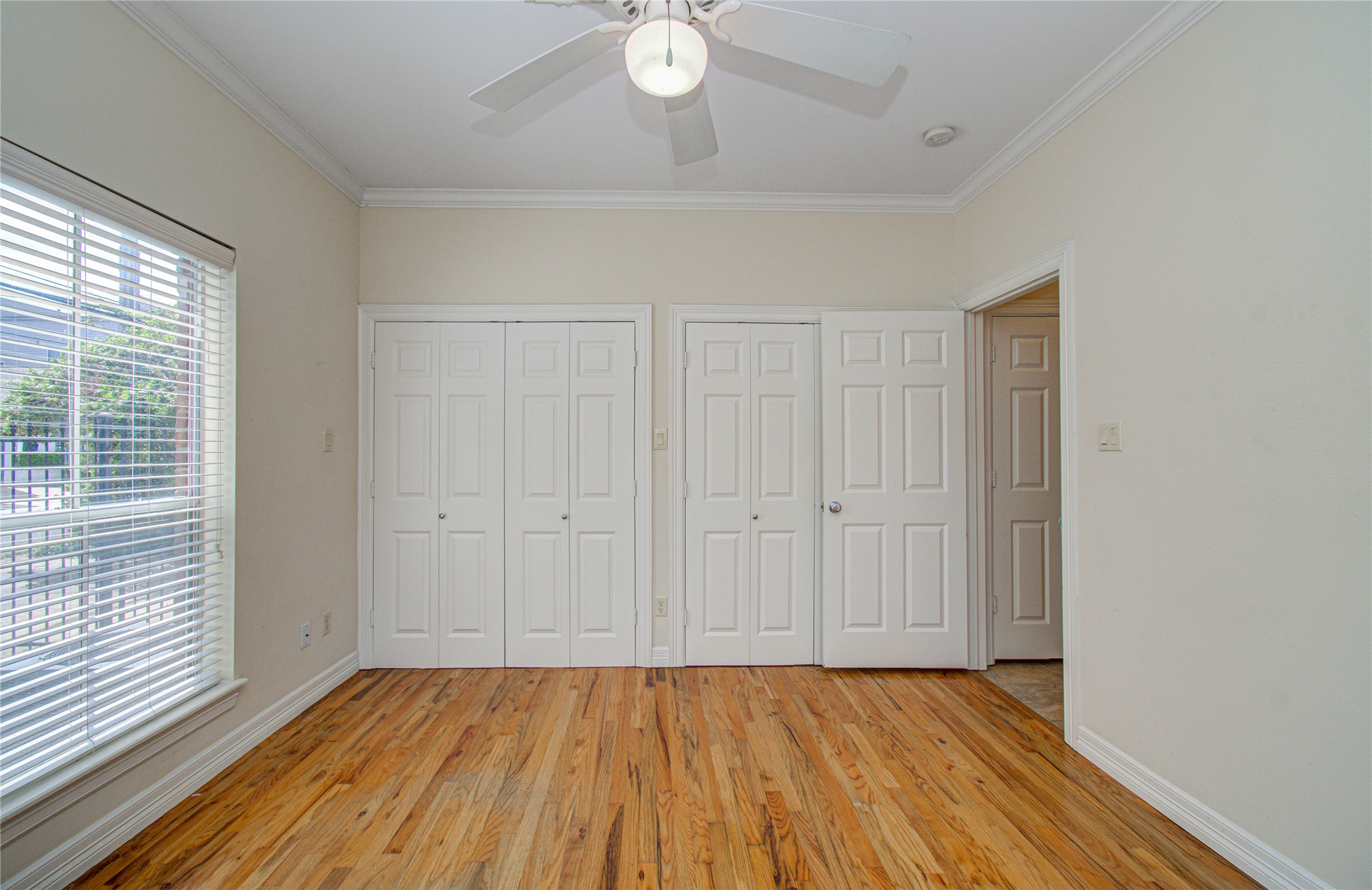 501 Leverkuhn Street Houston, TX 77007 - Photo 8 of 31 a view of an empty room with wooden floor and a window