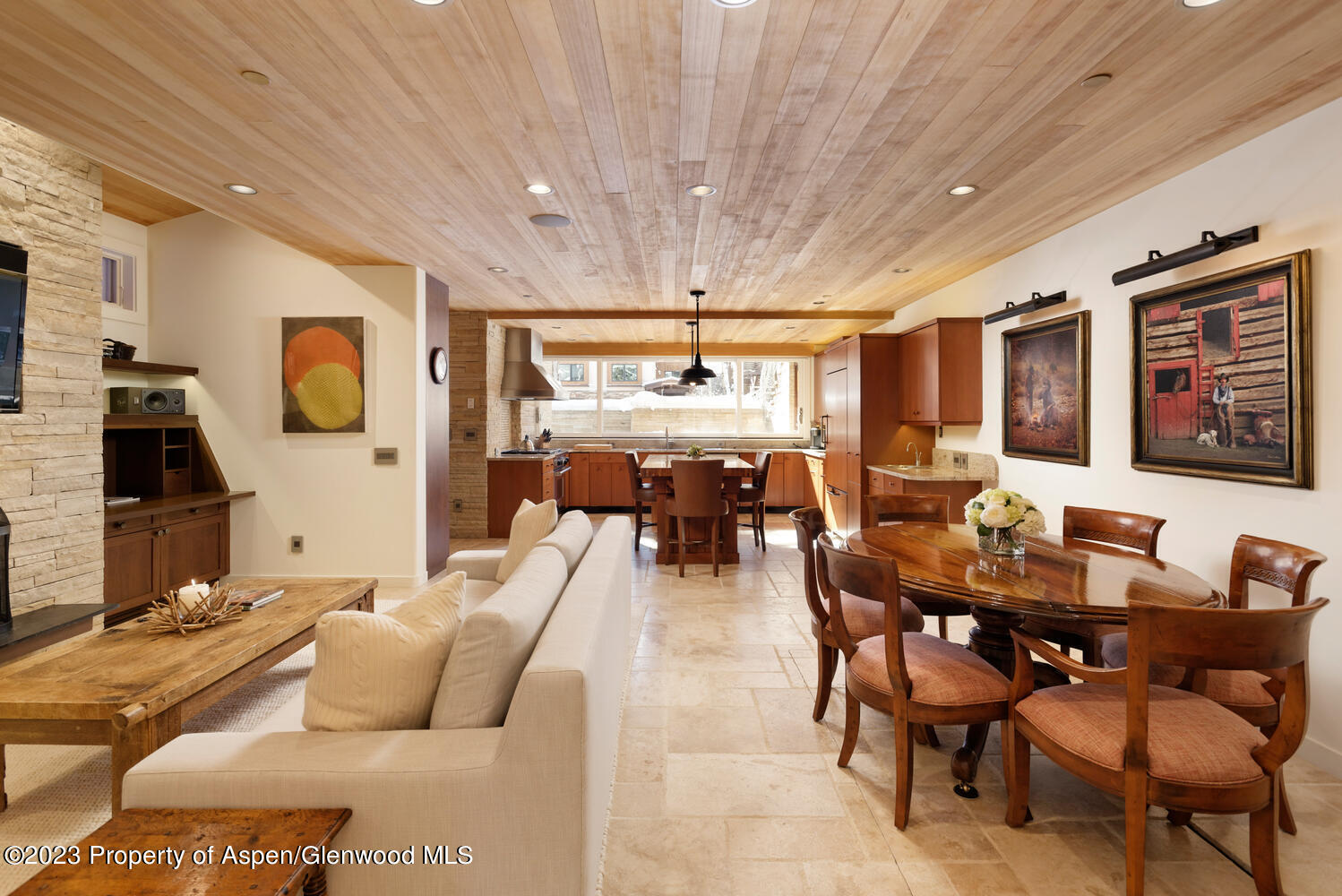 a living room with furniture a chandelier and a large window
