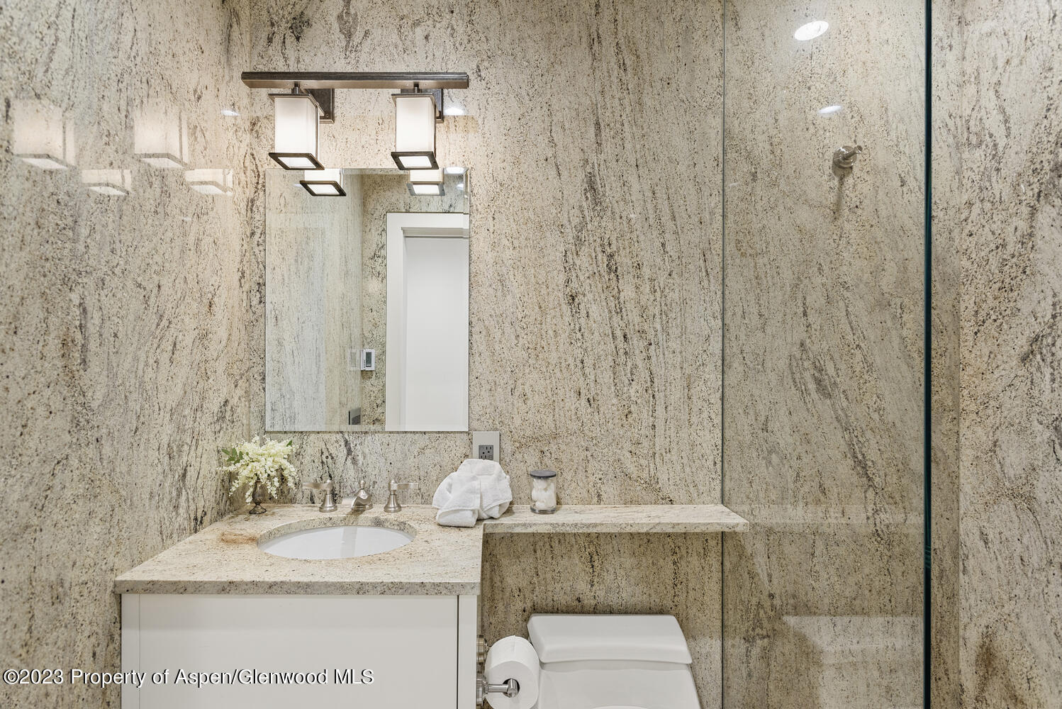 100 East Cooper Avenue, Unit 6 Aspen, CO 81611 - Photo 15 of 24 a bathroom with a granite countertop sink a toilet and shower