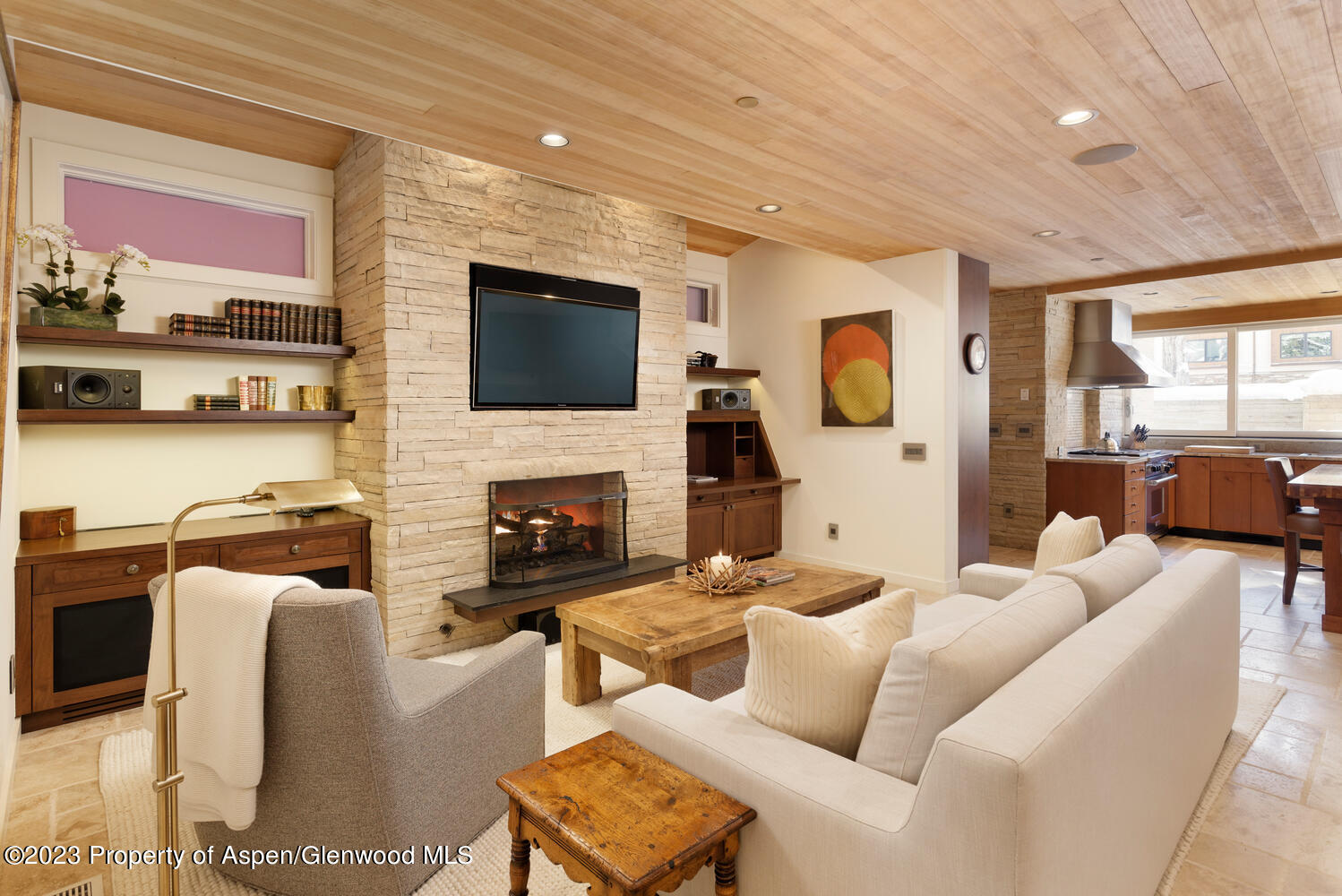 100 East Cooper Avenue, Unit 6 Aspen, CO 81611 - Photo 10 of 24 a living room with furniture a flat screen tv and a fireplace