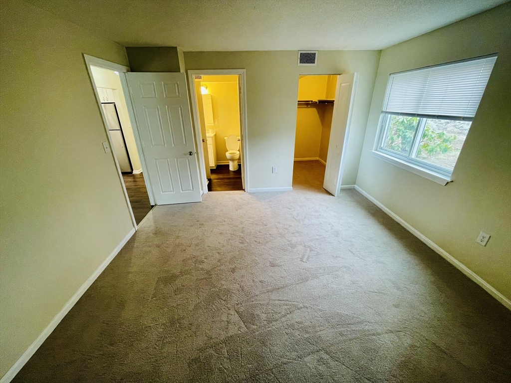 7 Beal's Cove Road, Unit 7A Hingham, MA 02043 - Photo 5 of 8 a view of an empty room with a fireplace