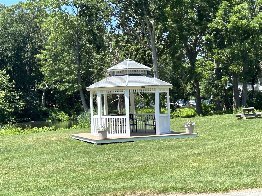 7 Beal's Cove Road, Unit 7A Hingham, MA 02043 - Photo 6 of 8 a front view of a house with a yard