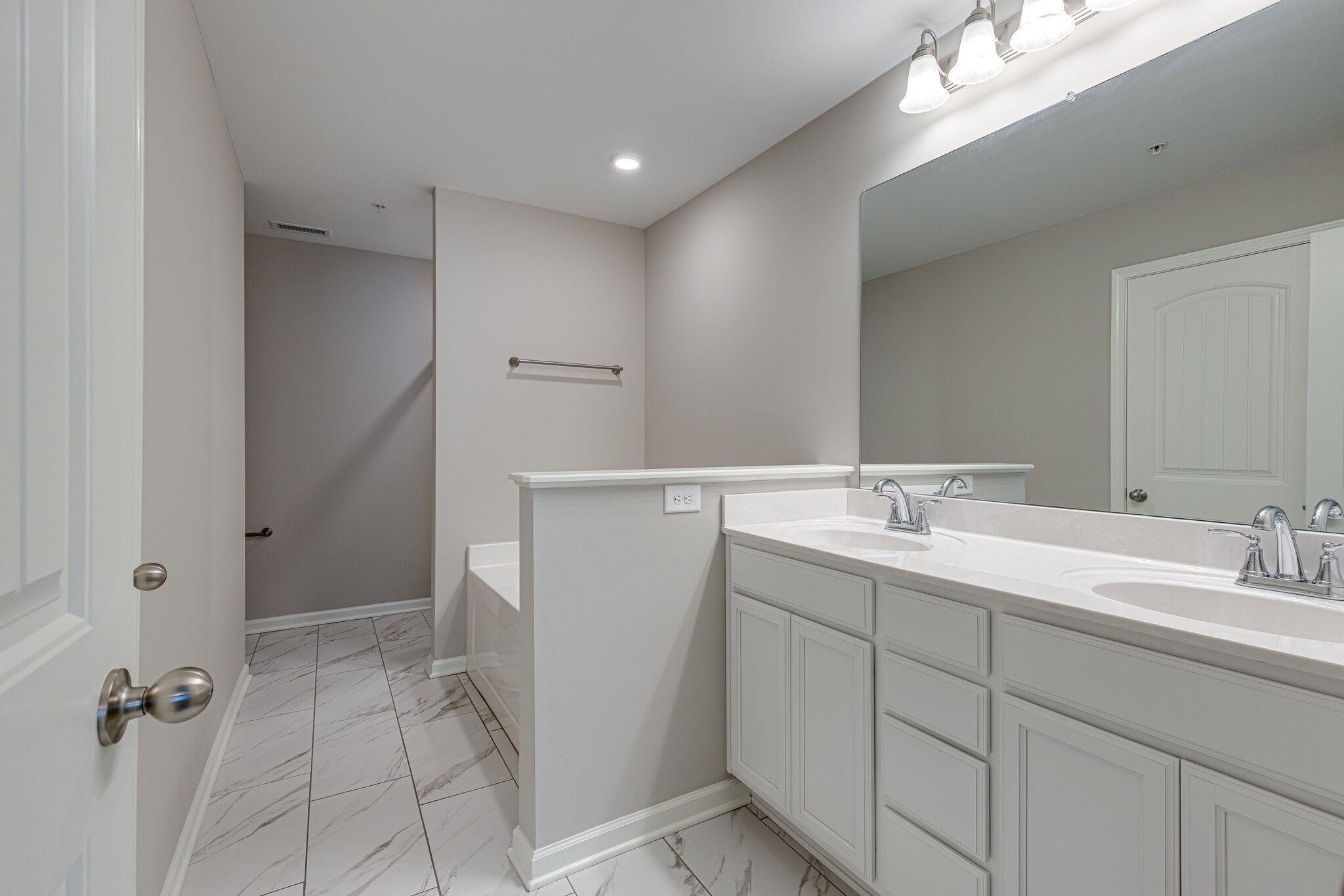 312 Mattie Ln Spring Hill Spring Hill, TN 37174 - Photo 21 of 37 a bathroom with a double vanity sink a mirror and a shower