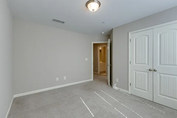an empty room with closet area