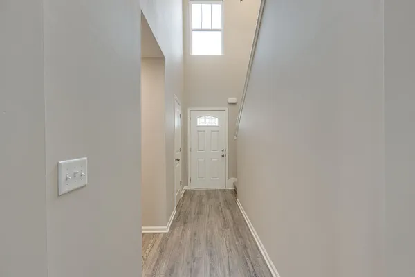 a view of a room with wooden floor