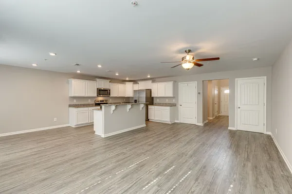 a view of kitchen with cabinets and wooden floor