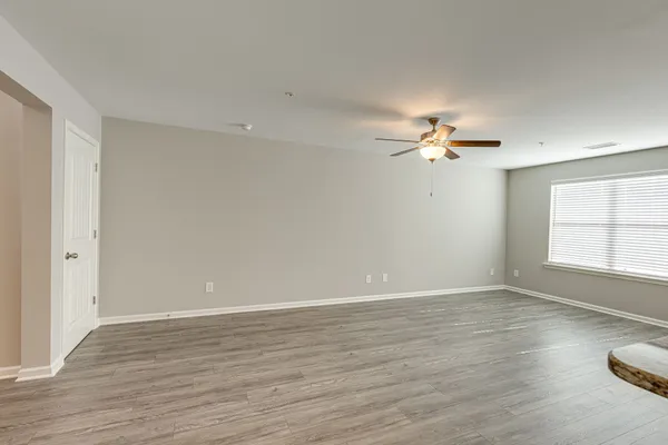 wooden floor in an empty room with a window