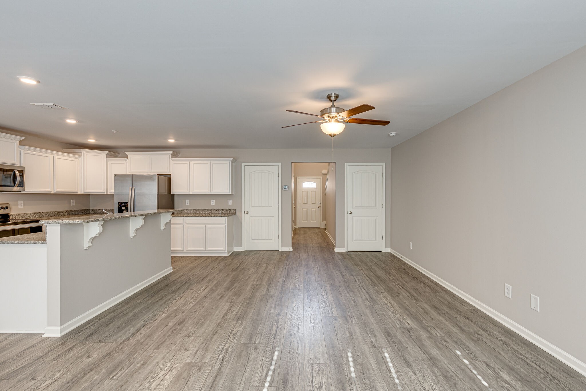 312 Mattie Ln Spring Hill Spring Hill, TN 37174 - Photo 10 of 37 a view of an empty room and kitchen with wooden floor