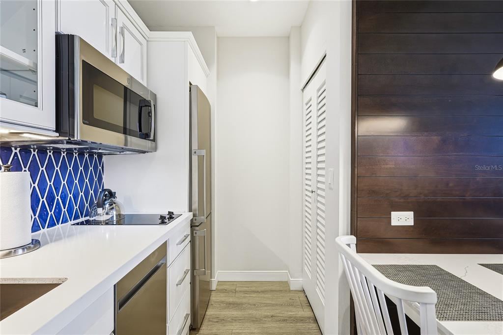 225 Sands Point Road, Unit 7101 Longboat Key, FL 34228 - Photo 12 of 44 a kitchen with a sink and a microwave