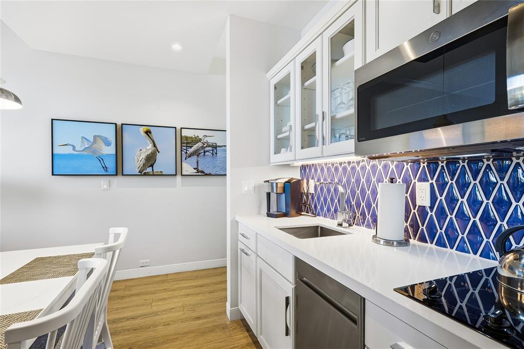 225 Sands Point Road, Unit 7101 Longboat Key, FL 34228 - Photo 13 of 44 a kitchen with a sink a stove and a microwave