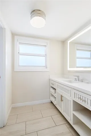 a bathroom with a sink a vanity and a mirror