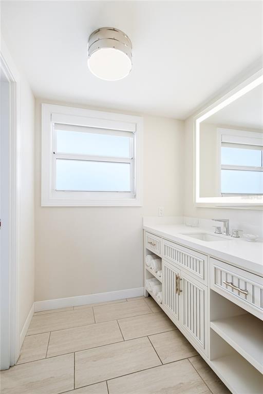 225 Sands Point Road, Unit 7101 Longboat Key, FL 34228 - Photo 18 of 44 a bathroom with a sink a vanity and a mirror