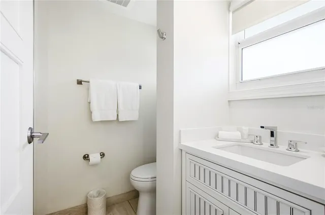 a bathroom with a sink toilet and vanity