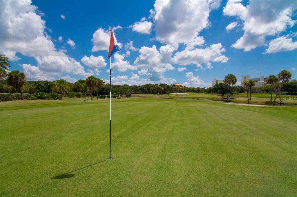 225 Sands Point Road, Unit 7101 Longboat Key, FL 34228 - Photo 30 of 44 a view of a golf course with a lake