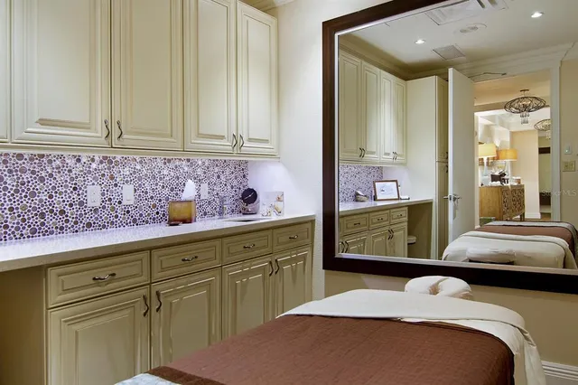 a bedroom with a bed and cabinets