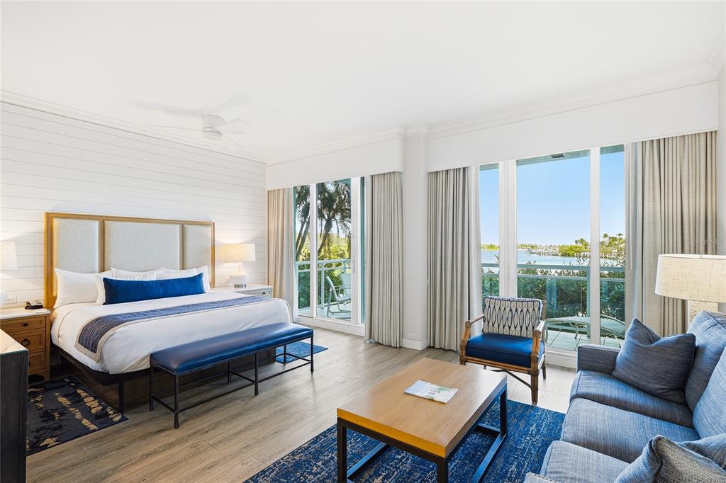 225 Sands Point Road, Unit 7101 Longboat Key, FL 34228 - Photo 4 of 44 a bedroom with a bed wooden floor and a large window