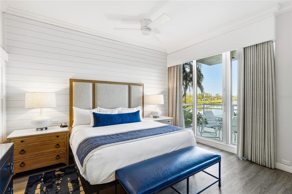 225 Sands Point Road, Unit 7101 Longboat Key, FL 34228 - Photo 5 of 44 a bedroom with a bed and wooden floor