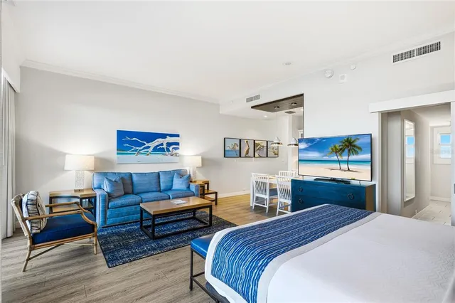 a bedroom with a bed and a view of kitchen