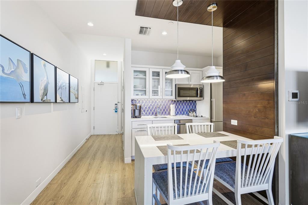 225 Sands Point Road, Unit 7101 Longboat Key, FL 34228 - Photo 10 of 44 a dining room with a wooden table and chairs