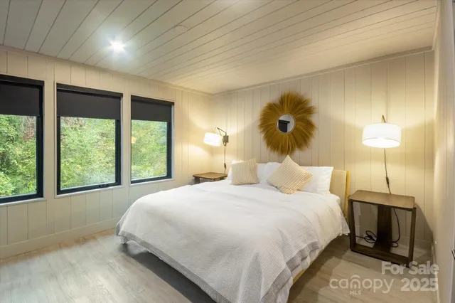 a front view of a house with a garden and plants