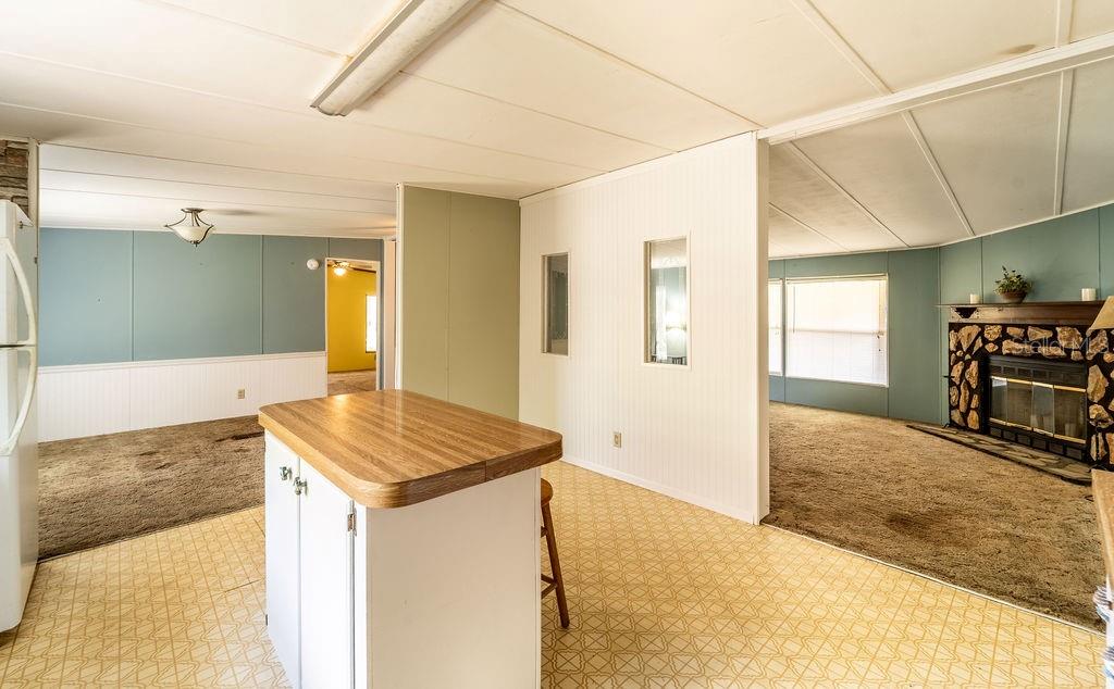 24031 Armadillo Road Astor, FL 32102 - Photo 11 of 43 a view of a kitchen cabinets and wooden floor