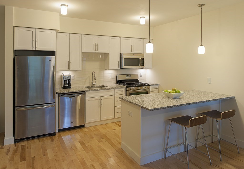 603 Concord, Unit 406 Cambridge, MA 02138 - Photo 1 of 11 a kitchen with a sink stainless steel appliances and white cabinets