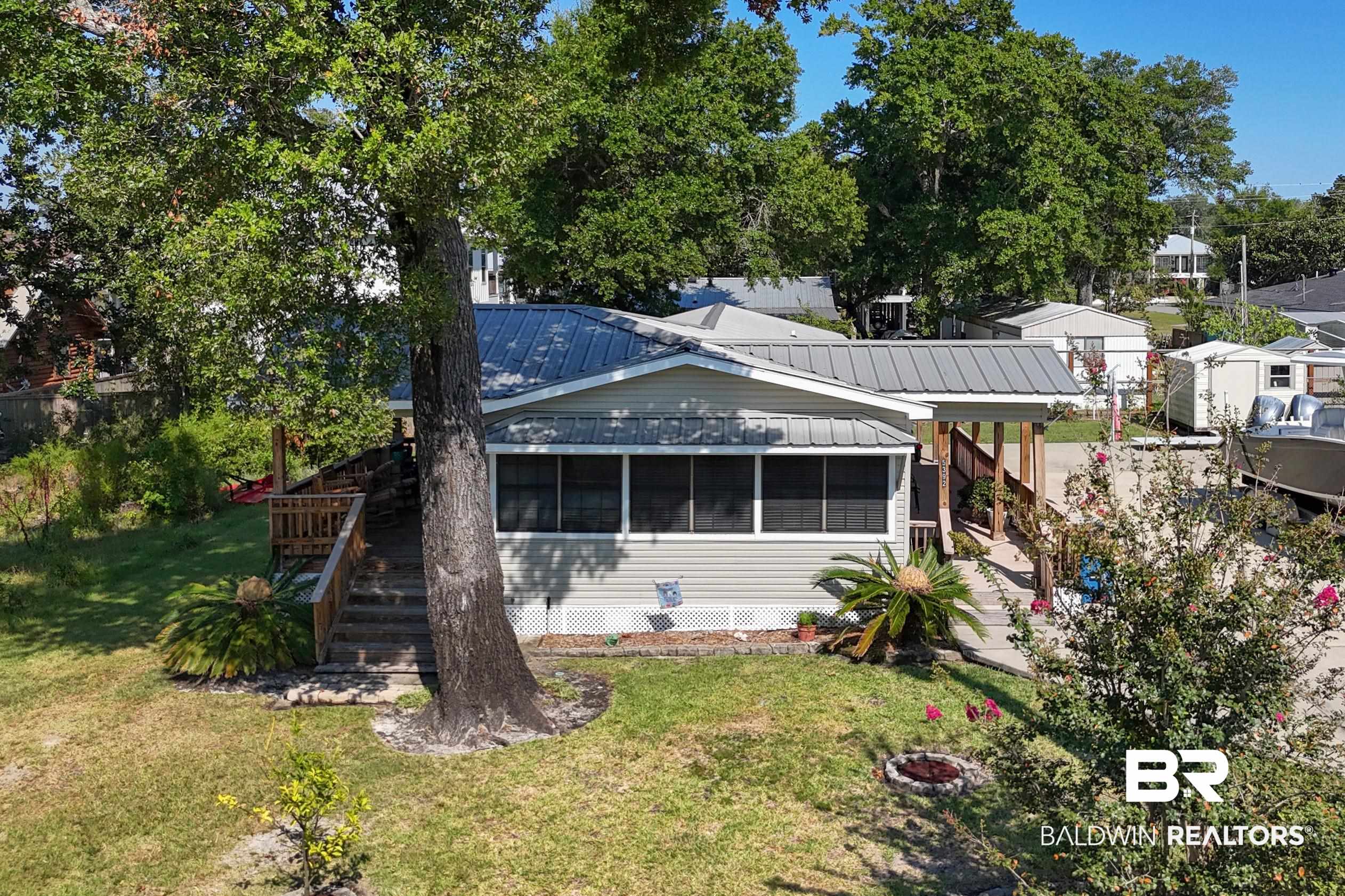 5392 Ornacor Avenue Orange Beach, AL 36561 - Photo 40 of 48 Back of property featuring a yard and a sunroom