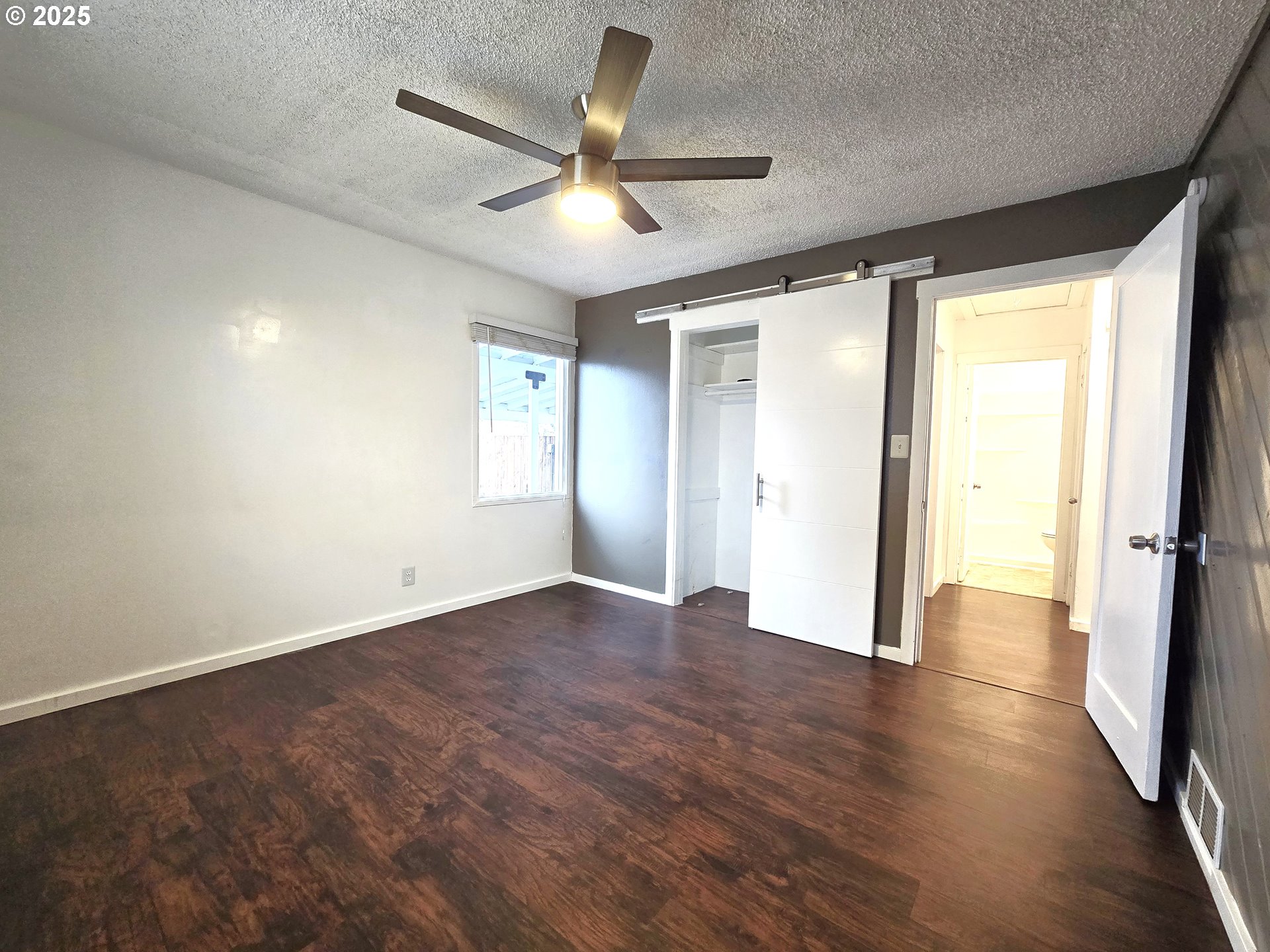 460 East Sunset Drive Hermiston, OR 97838 - Photo 11 of 32 an empty room with wooden floor and windows