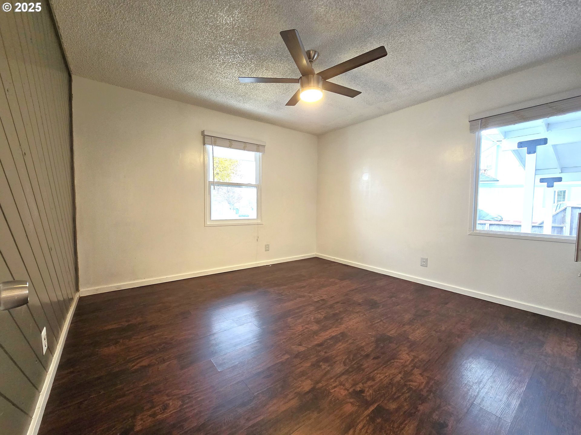 460 East Sunset Drive Hermiston, OR 97838 - Photo 10 of 32 an empty room with wooden floor fan and windows