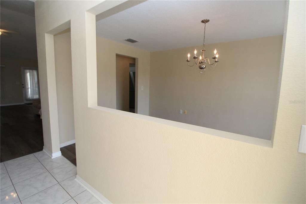 7432 Perennial Road North Port, FL 34291 - Photo 11 of 61 a view of a hallway with a chandelier