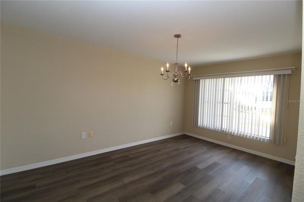 7432 Perennial Road North Port, FL 34291 - Photo 12 of 61 a view of an empty room with wooden floor and a window