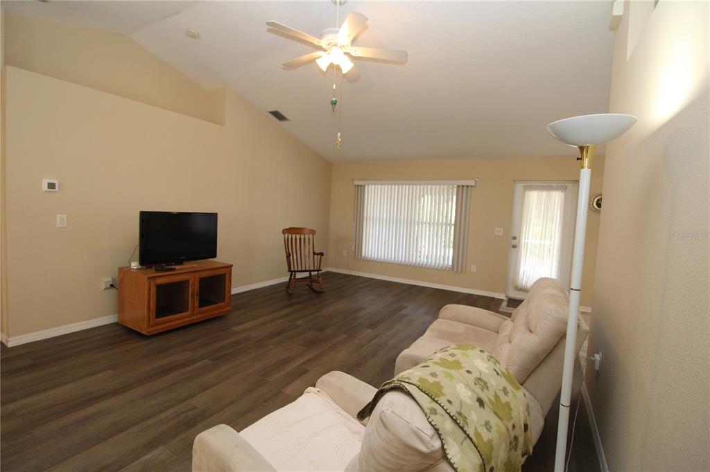 7432 Perennial Road North Port, FL 34291 - Photo 15 of 61 a living room with furniture and a flat screen tv