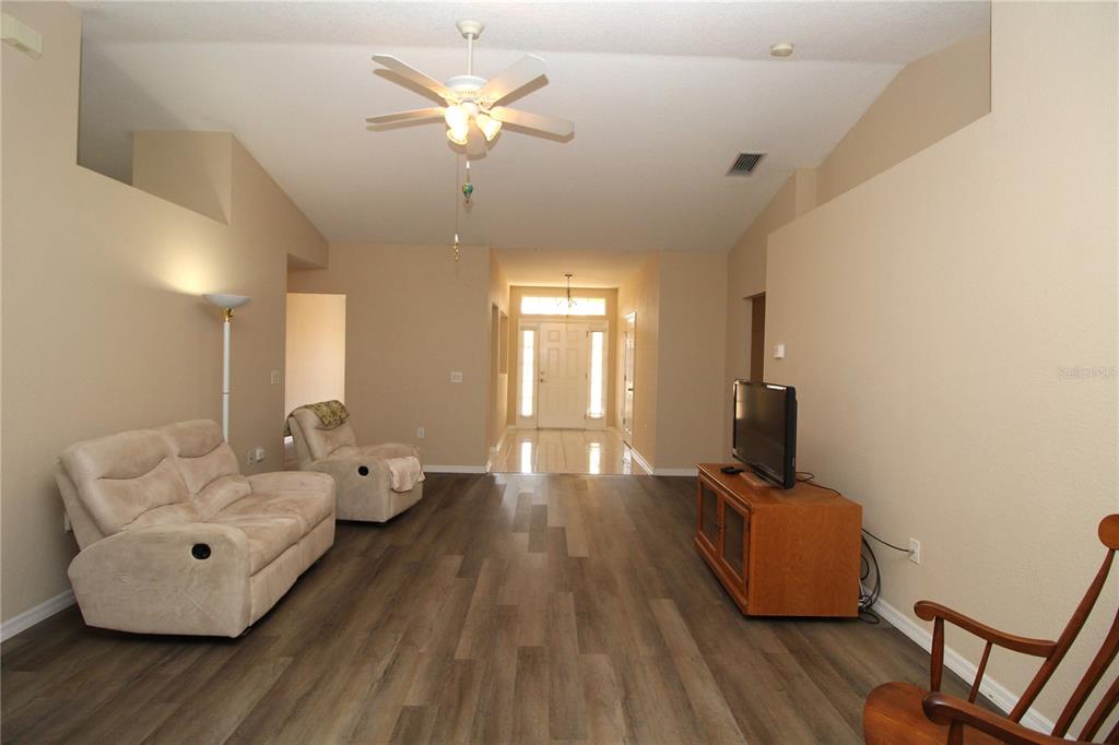 7432 Perennial Road North Port, FL 34291 - Photo 16 of 61 a living room with furniture and a chandelier