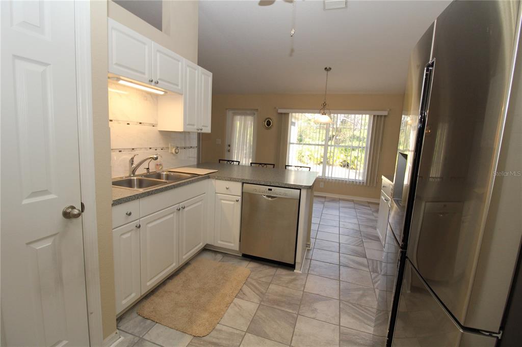 7432 Perennial Road North Port, FL 34291 - Photo 25 of 61 a kitchen with a sink a stove a refrigerator and window